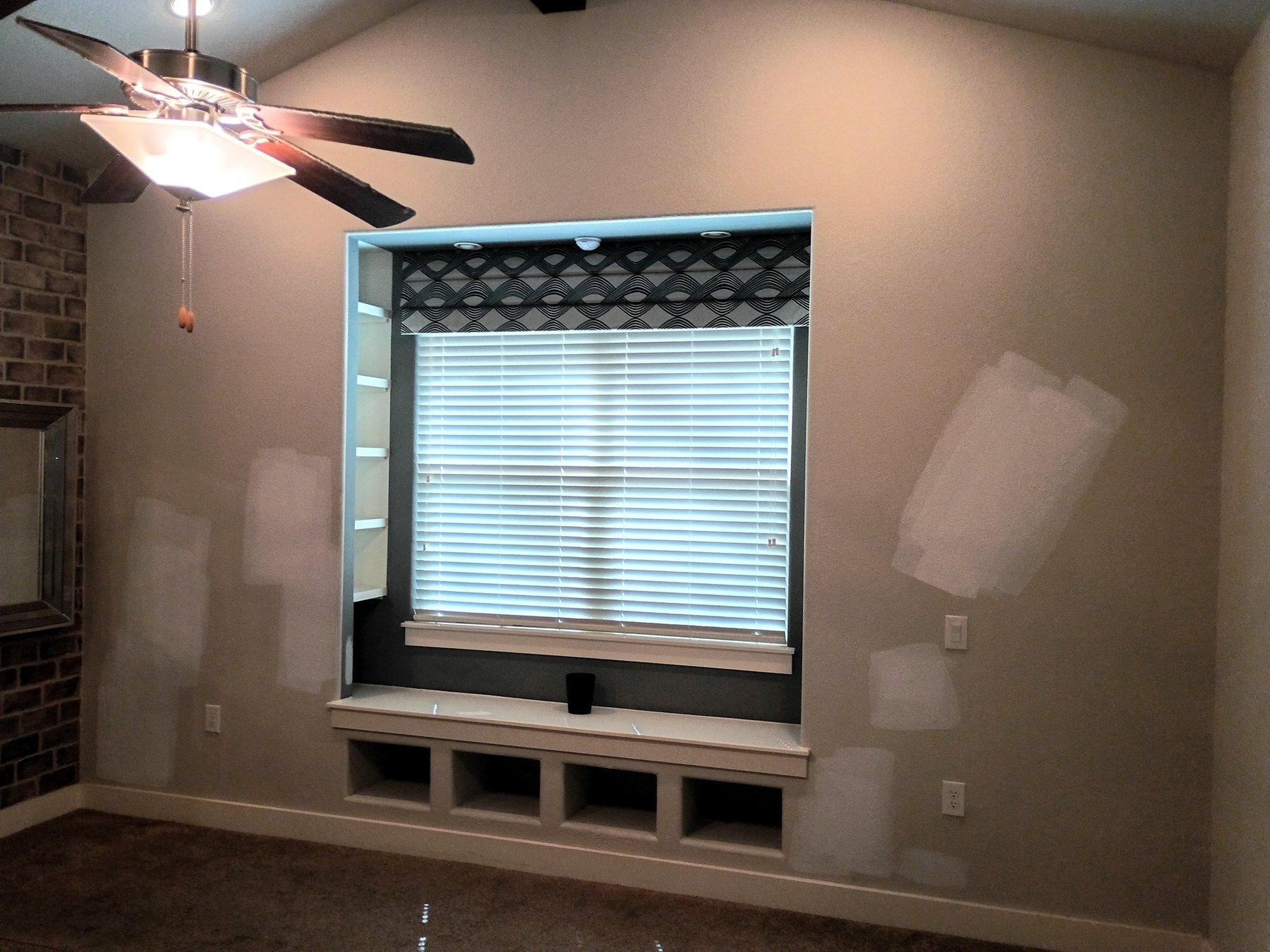 Patched wall areas around a window prepared for repainting during an Austin residential make-ready.
